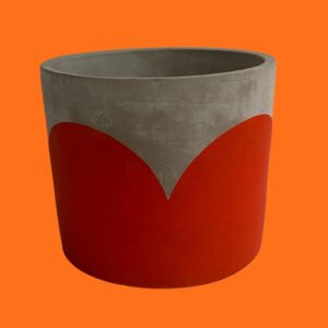 concrete indoor use plant pot with red painted heart design on an orange background