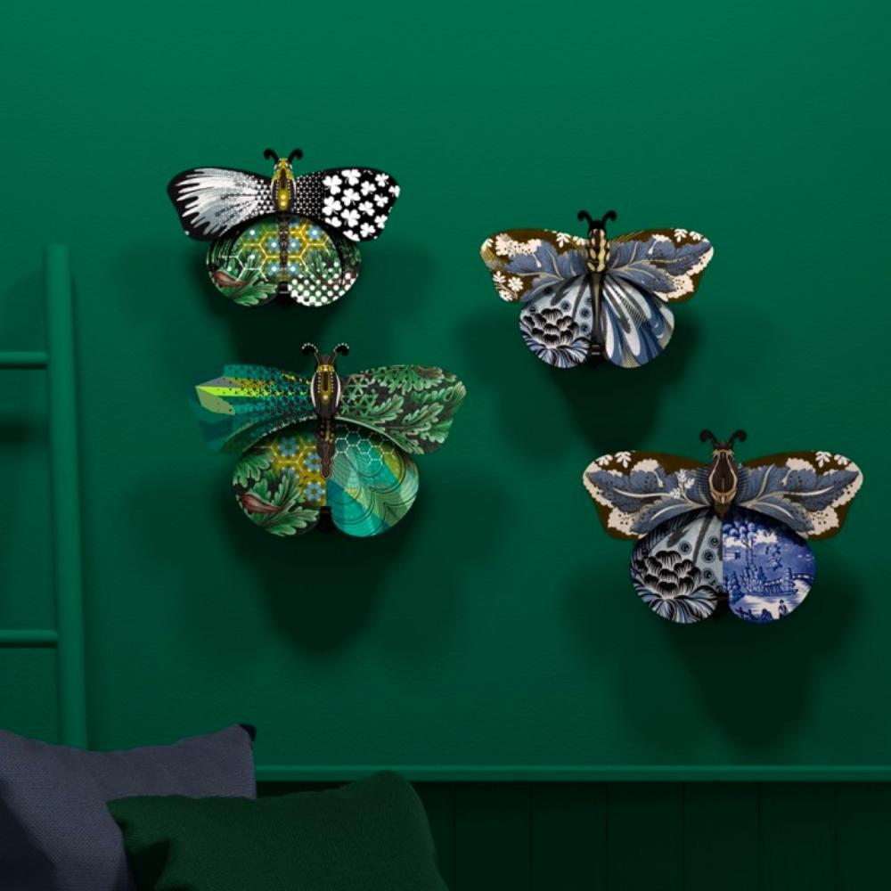four patterned 3d ornamental hanging decorative wall art butterflies on a green background
