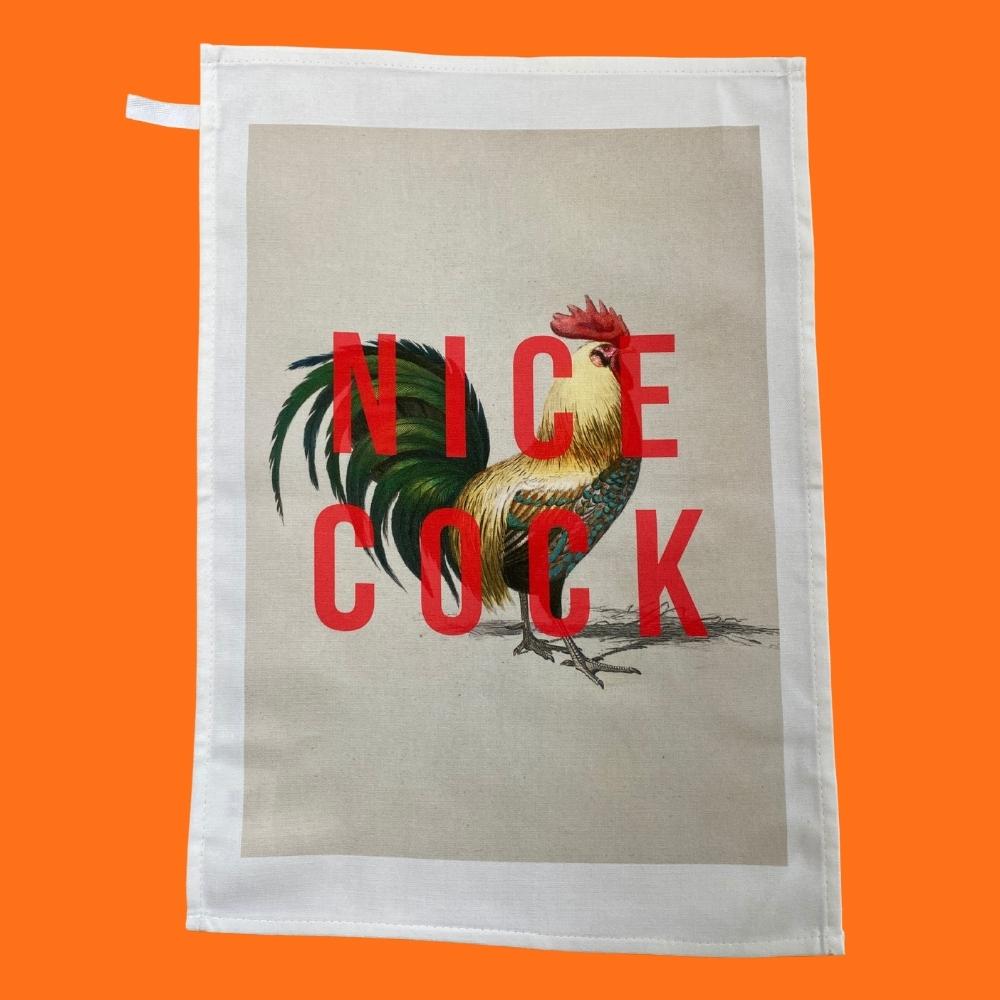 cheeky white based cotton tea towel with an image of a cockerel and the words nice cock in red
