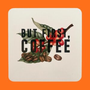 square drinks coaster with rounded edges featuring a coffee leave, coffee bean and coffee berry cherry print with black text that says but first coffee