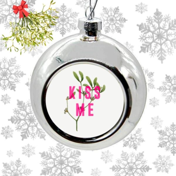 Silver bauble with pink Kiss Me text and Mistletoe image Christmas Tree Bauble Ornament Xmas Decoration on a snowflake background