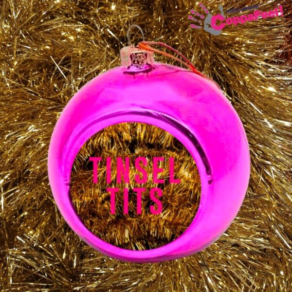 Pink bauble with the words Tinsel Tits on a gold tinsel background