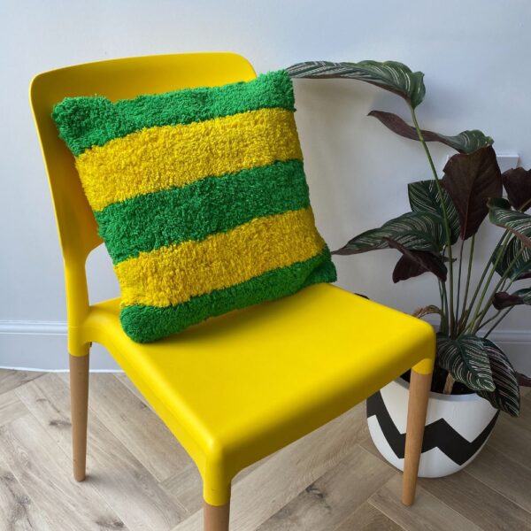 Striped Yellow & Green Maximalist Decor Cushion on a yellow chair