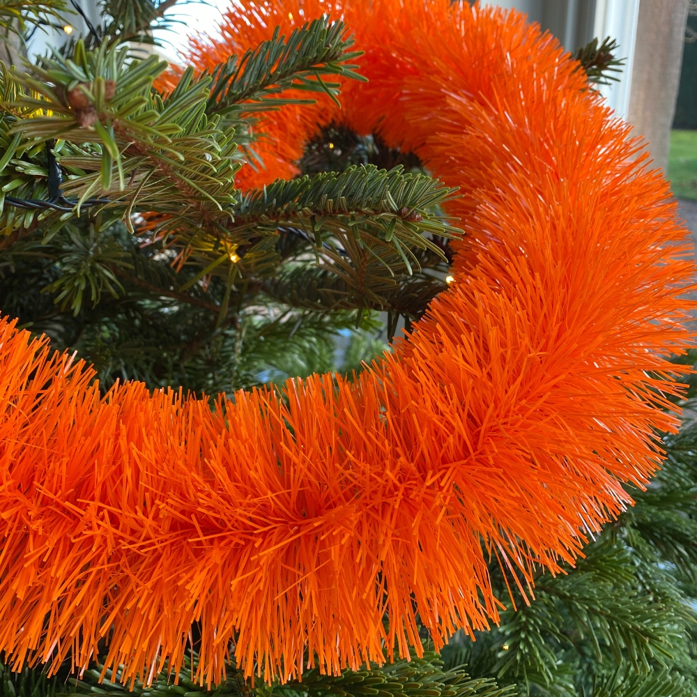 orange recycled sustainable eco-friendly tinsel on a christmas tree