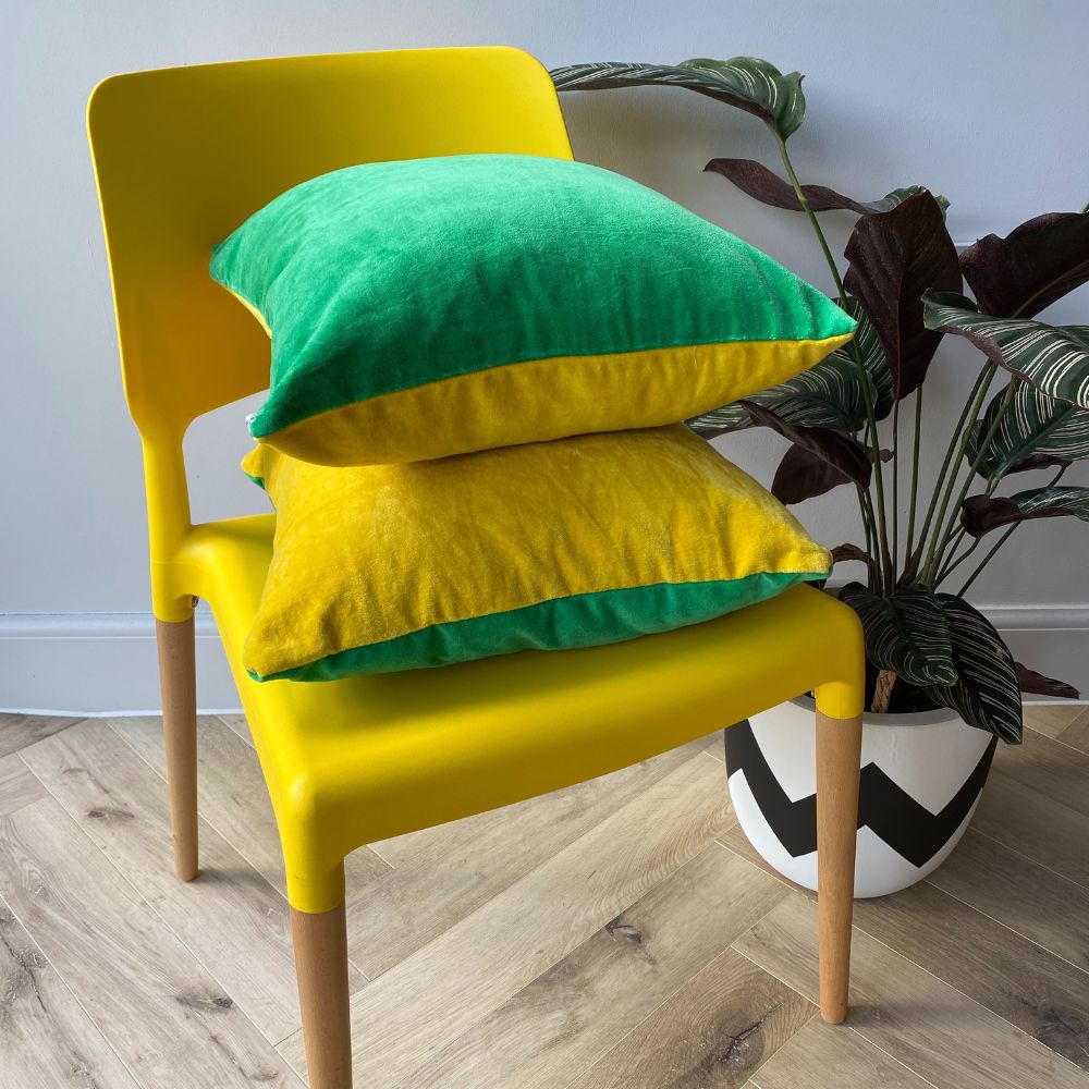 Yellow chair with two two tone green and yellow reversible colourful velvet cushions on