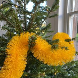 Neon Yellow Recycled Tinsel Eco-Friendly Reusable Garland on a Christmas tree