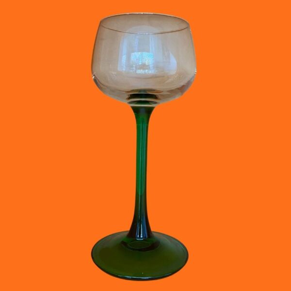 preloved mid century flared green stem wine glass on an orange background